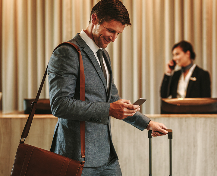 business man in a hotel lobby with luggage
