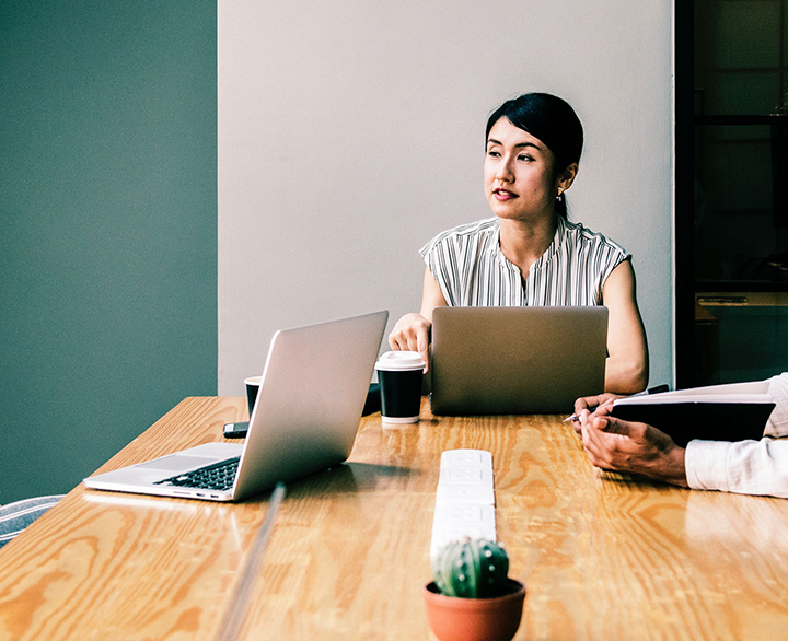 business woman at the head of a conference table meeting