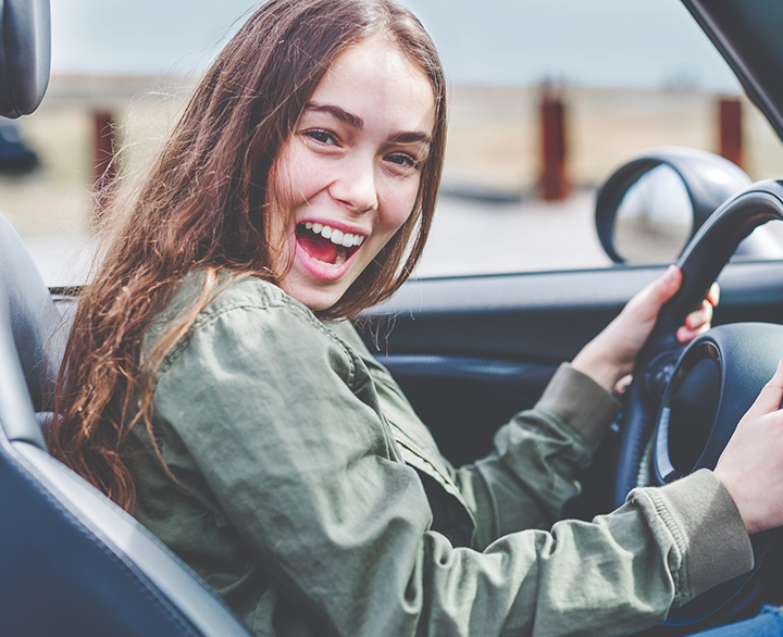 woman driving her new car