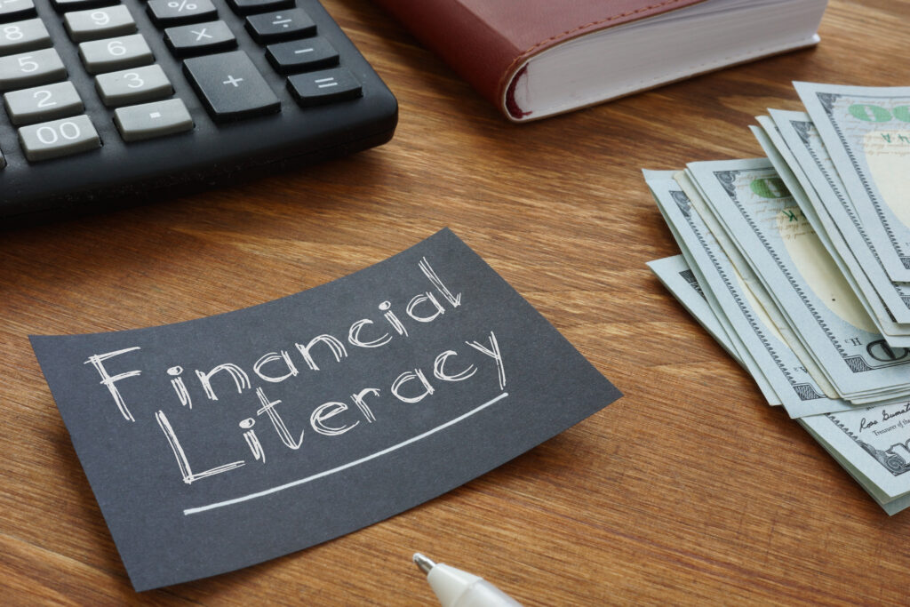 Financial Literacy is shown written on a piece of paper.